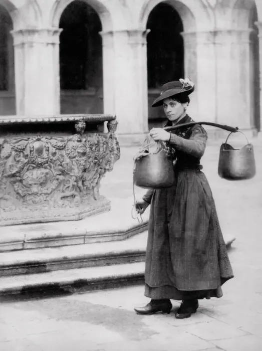 Framed Print : Female water carrier at a well, Venice, Italy Framed Print : Female water carrier at a well, Venice, Italy