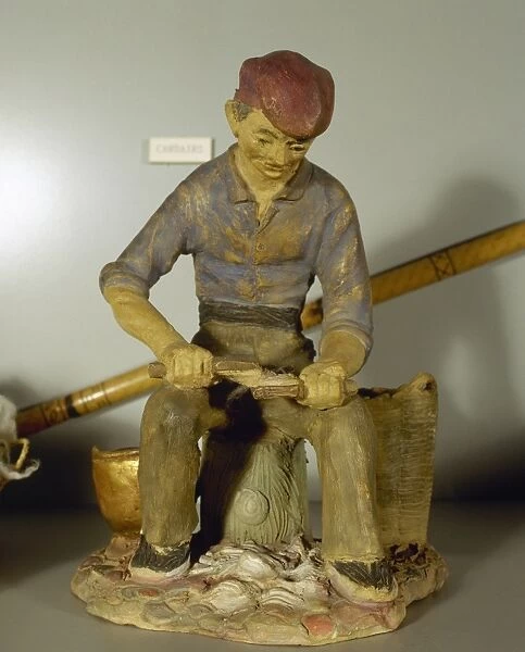 Figurine depicting a carder