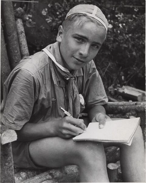 Finnish boy scout writing in a notebook