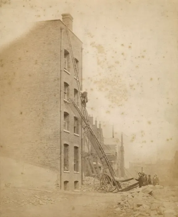 Framed Print : A firefighter in action on a wheeled ladder escape Framed Print : A firefighter in action on a wheeled ladder escape