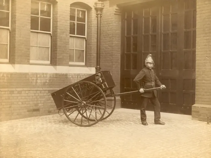 Framed Print : A firefighter of the London Fire Brigade pulling a cart Framed Print : A firefighter of the London Fire Brigade pulling a cart