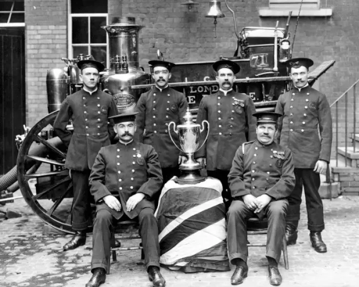 Framed Print : Firefighters pose in front of a steam pump Framed Print : Firefighters pose in front of a steam pump