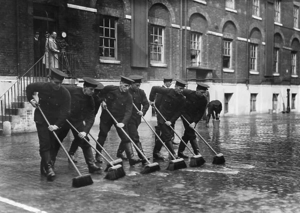 Firefighters with sweeping brushes, Southwark HQ