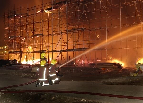 Firefighters working at fire on building site