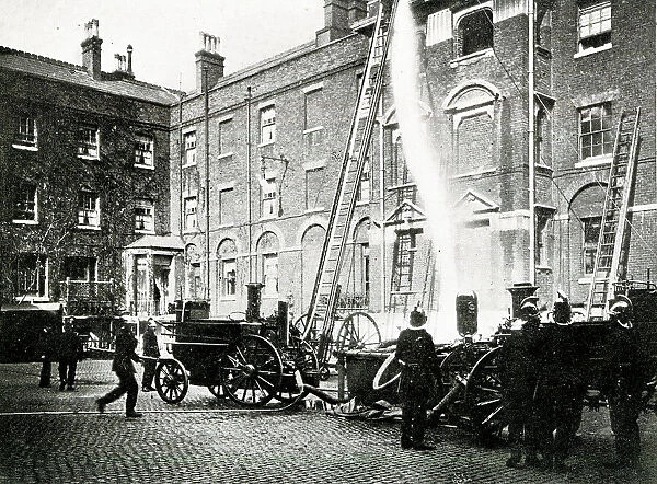 Firemen and fire engine at work in London