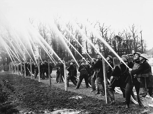 Firemen at hose drill during World War II Date: 1941