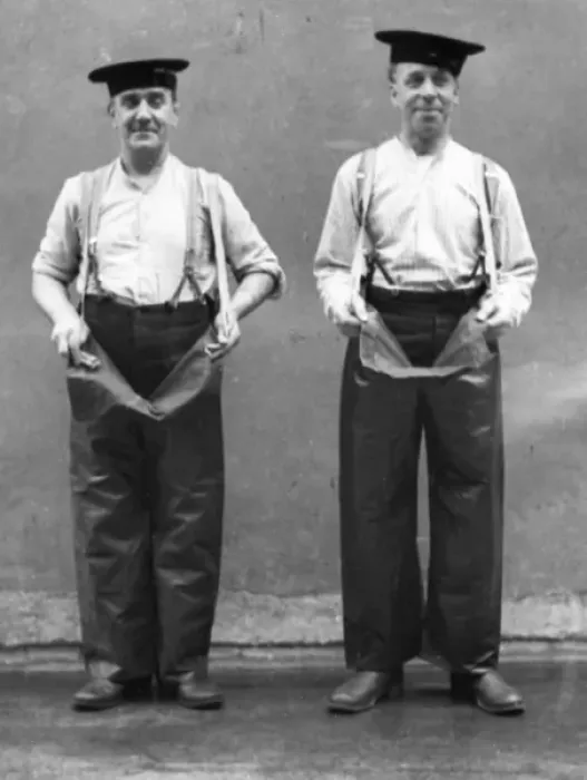 Framed Print : Two firemen modelling waterproof leggings Framed Print : Two firemen modelling waterproof leggings