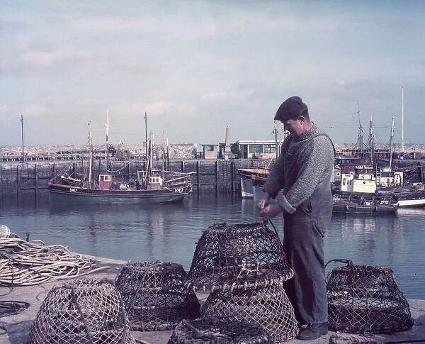 Fisherman with lobster pots, Brixham Harbour, Devon