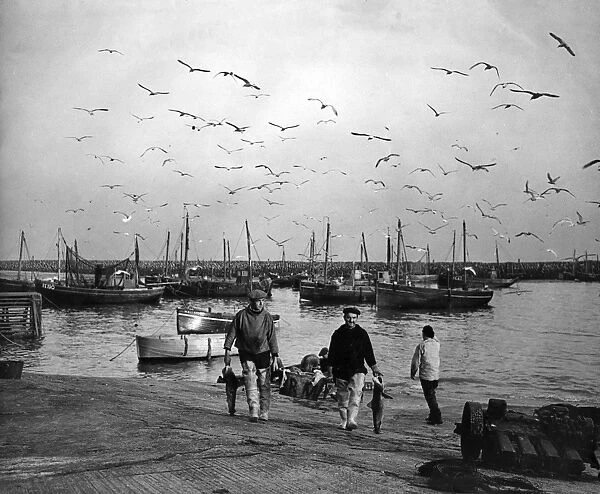 Fishermen and boats in a harbour