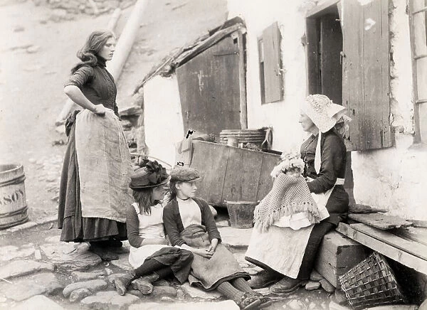 Fishing family outside their cottage, Staithes, Yorkshire