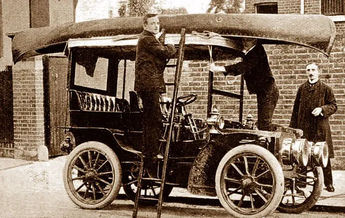Framed Print : Fixing a canoe to the top of a veteran car, early 1900s Framed Print : Fixing a canoe to the top of a veteran car, early 1900s