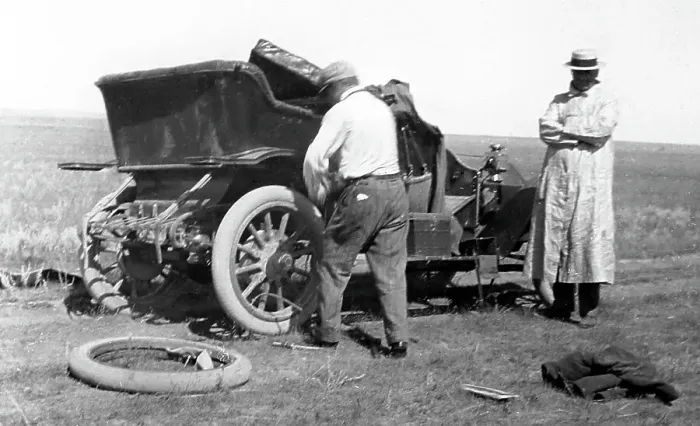 Framed Print : Fixing a puncture, early 1900s Framed Print : Fixing a puncture, early 1900s