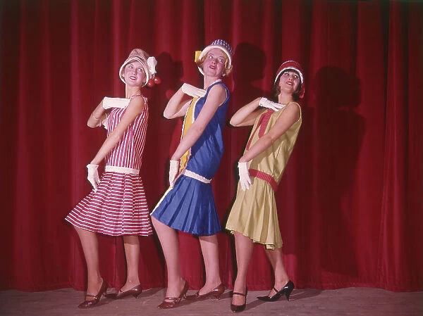 Three flappers in cloche hats - a 1960s version of 1920s style! Date: 1960s