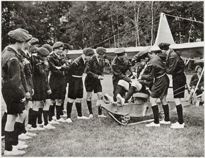 Framed Print : Flt.Lieut. Wilson helping to adjust the equipment of the pilot as one of the boys prepares to take off in a glider. Date: 1959 Framed Print : Flt.Lieut. Wilson helping to adjust the equipment of the pilot as one of the boys prepares to take off in a glider. Date: 1959
