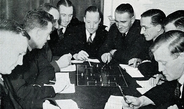Football referees studying the rules of the game