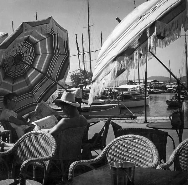France / Nice 1930S. A fashionable couple reading newspapers under the shade