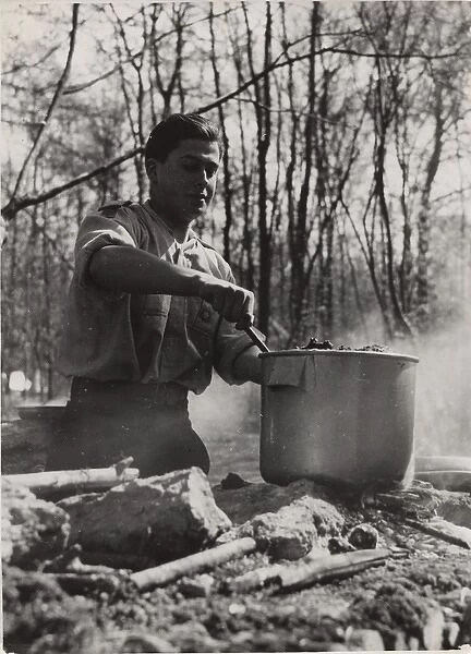 French boy scout cooking at camp