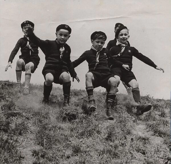 French cub scouts sliding down a slope