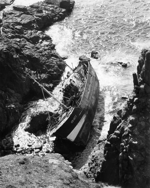 French fishing boat on rocks, Dollar Cove, Cornwall