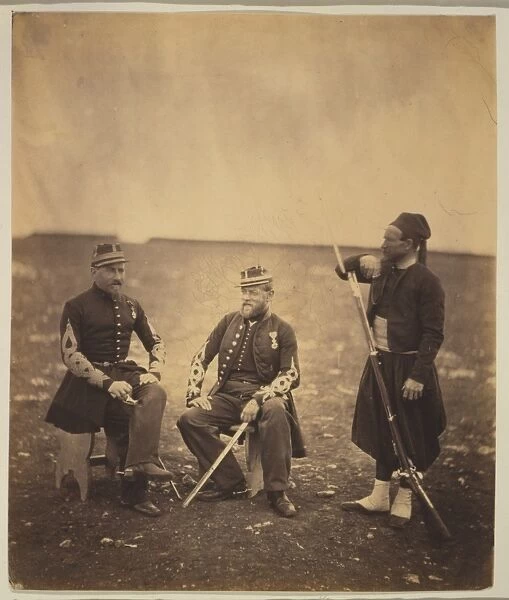 Two French officers, seated, and Zouave, standing with arm r