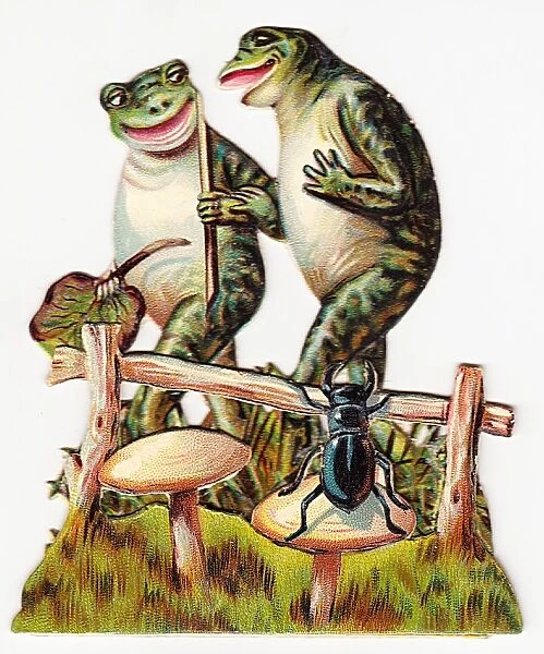 Two frogs and beetle on a cutout greetings card