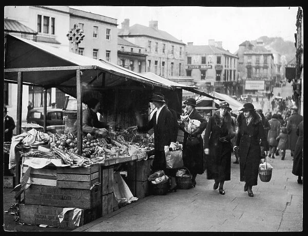 Frome Market 1930S. Well-dressed ladies carrying heavy wicker baskets of shopping