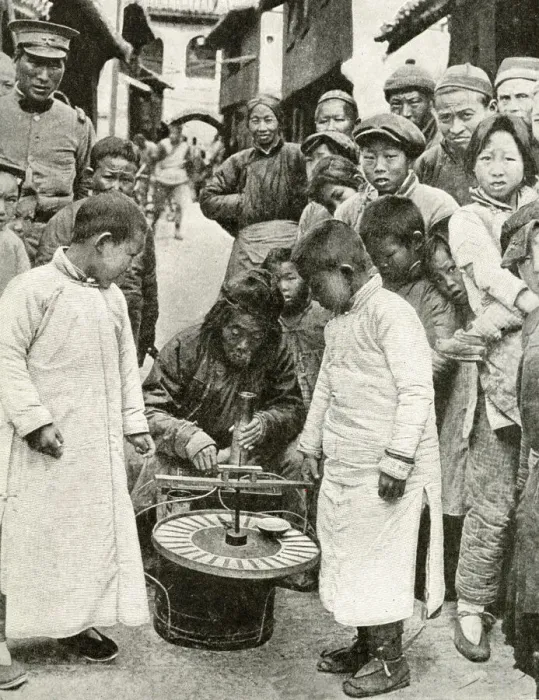 Framed Print : Gambling for sweets at roulette wheel, China, East Asia Framed Print : Gambling for sweets at roulette wheel, China, East Asia