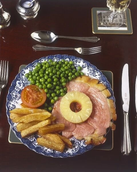 Gammon & Pineapple. Gammon, ham, chips and peas, garnished with tomato. Date: 1980s