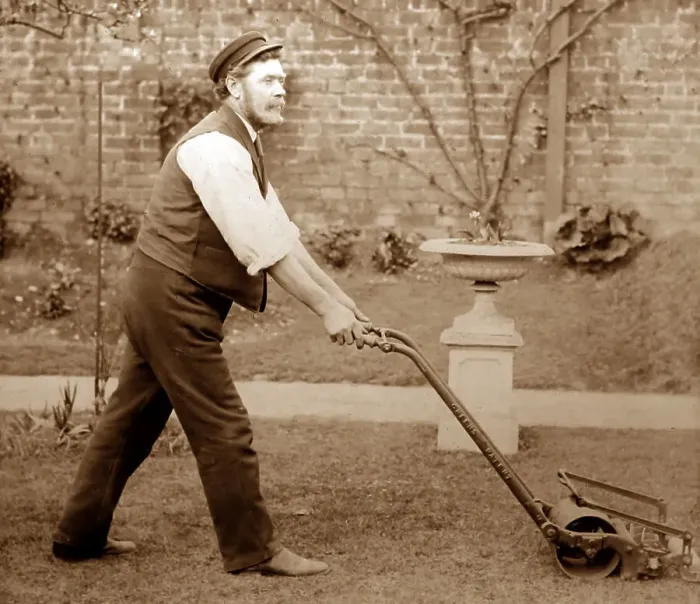 Framed Print : Gardener mowing a lawn with a Thomas Green lawnmower Framed Print : Gardener mowing a lawn with a Thomas Green lawnmower