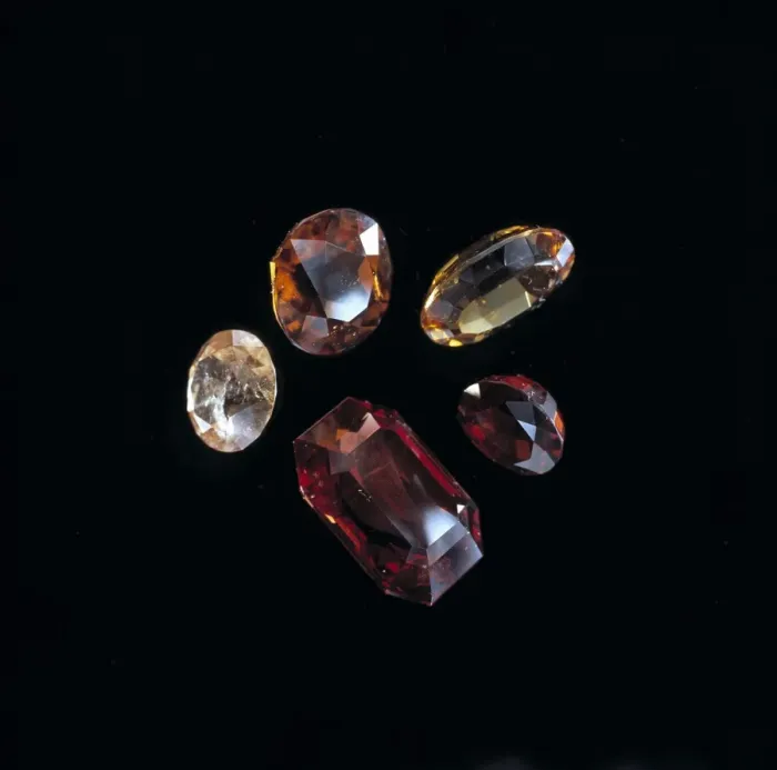 Framed Print : Garnets. Faceted garnets showing a range of colours. Garnet is the birthstone of January Framed Print : Garnets. Faceted garnets showing a range of colours. Garnet is the birthstone of January