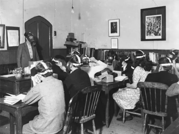 Framed Print : Gas Masks. Students wearing gas masks while studying during World War II Framed Print : Gas Masks. Students wearing gas masks while studying during World War II
