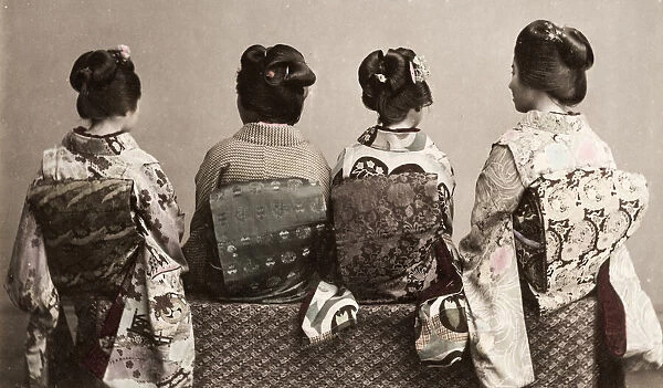 Geishas showing ornate kimonos and obi sashes, Japan