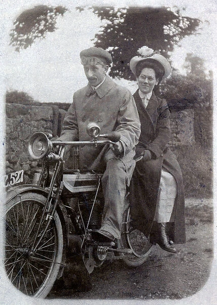 Gentleman & lady on a 1910 Triumph motorcycle