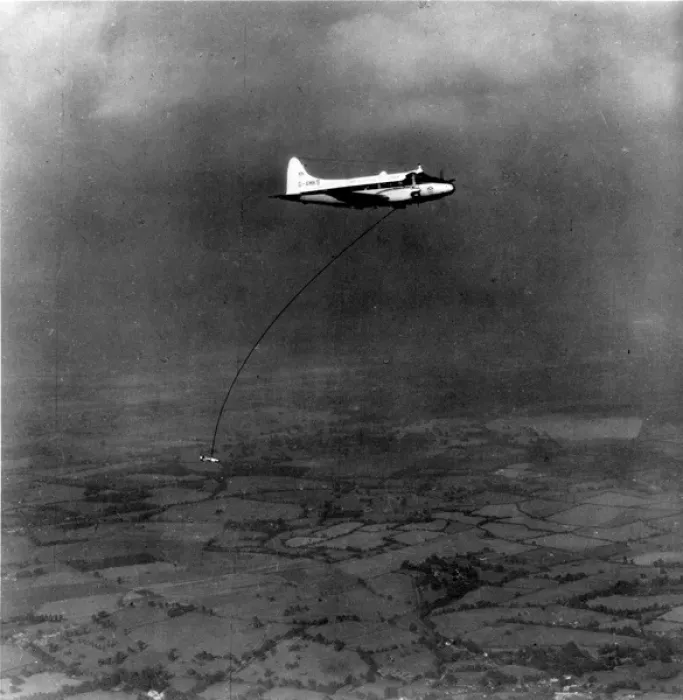 Framed Print : A geophysical survey bird towed by de Havilland DH104 Dove