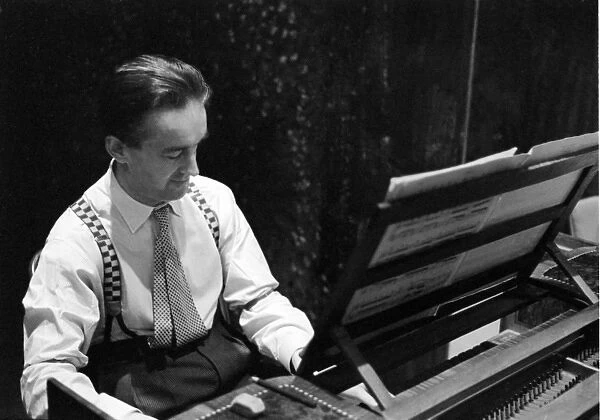 George Malcolm playing the harpsichord