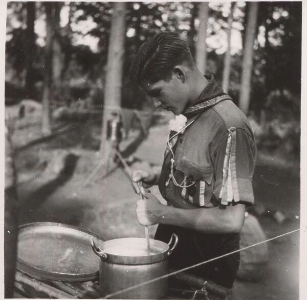 German boy scout cooking at camp