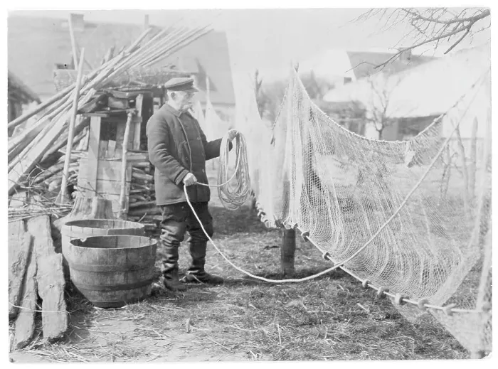 Framed Print : A German fisherman mending his nets Framed Print : A German fisherman mending his nets