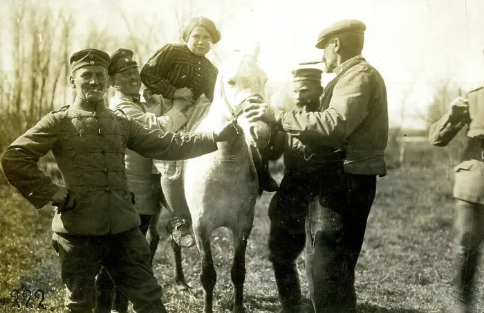 Framed Print : German soldiers help farmer's wife onto a horse, WW1 Framed Print : German soldiers help farmer's wife onto a horse, WW1