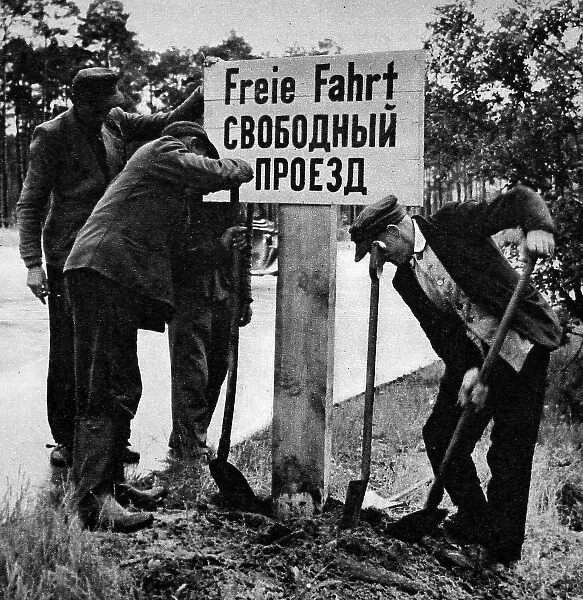 German Workers Re-erecting a Free Passage Sign, Berlin, 19