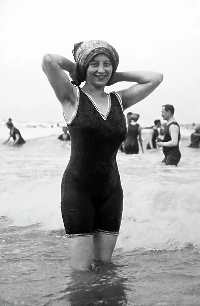 Girl in bathing costume at the seaside, early 1900s