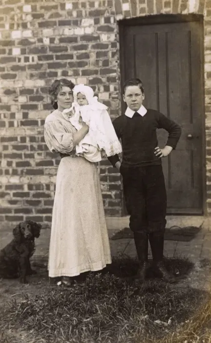 Framed Print : Girl and boy with baby and spaniel outside a house Framed Print : Girl and boy with baby and spaniel outside a house