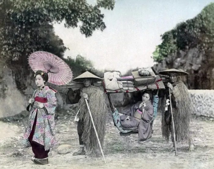 Framed Print : Girl in carrying chair with bearers in grass coats, Japan Framed Print : Girl in carrying chair with bearers in grass coats, Japan