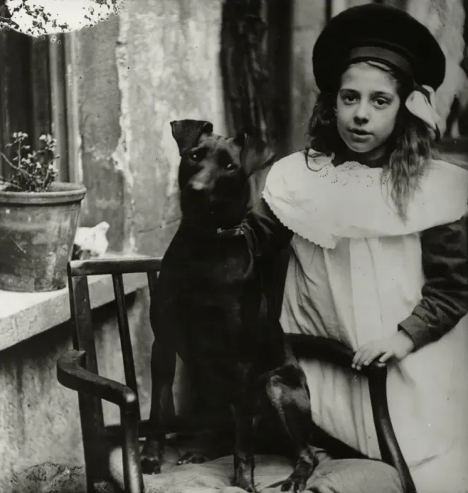 Framed Print : Girl with dog outside a house Framed Print : Girl with dog outside a house