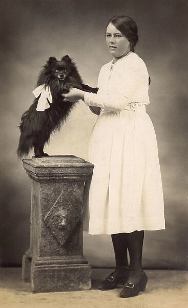Girl with dog in studio photo