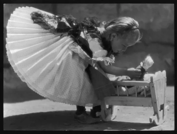 Framed Print : Girl and Doll in Crib Framed Print : Girl and Doll in Crib