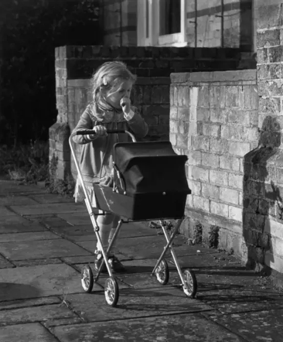 Framed Print : Girl with doll and pram, Balham, SW London Framed Print : Girl with doll and pram, Balham, SW London