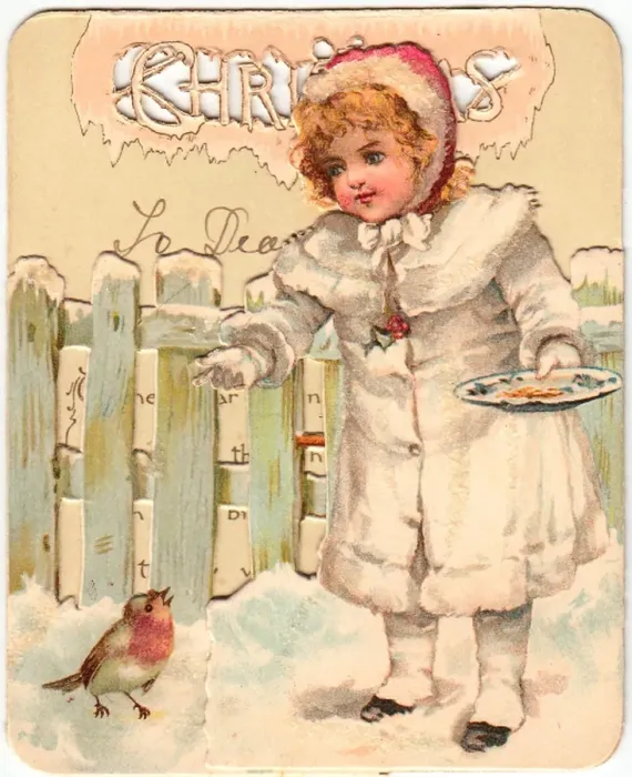 Framed Print : Girl feeding robin in the snow on a Christmas card