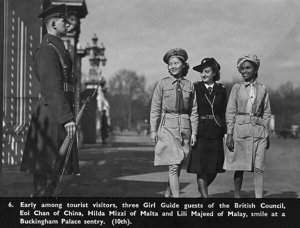 Three girl guides outside Buckingham Palace