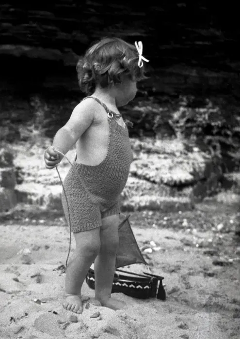 Framed Print : Girl in knitted swimsuit with model boat Framed Print : Girl in knitted swimsuit with model boat
