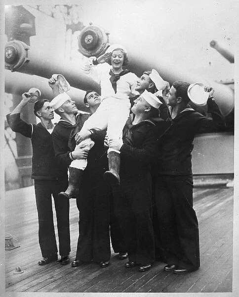 Girl Naval Mascot. Sailors of the American Navy holding up their girl mascot